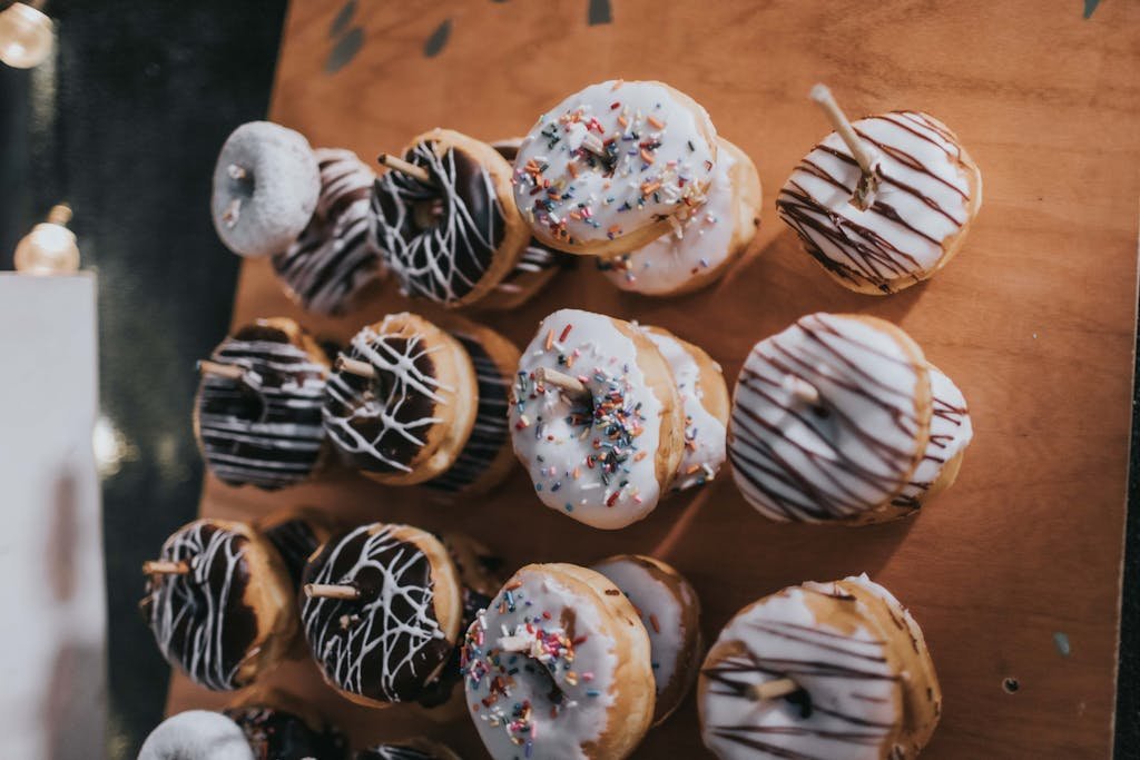 Donuts Hanging On Wooden Surface