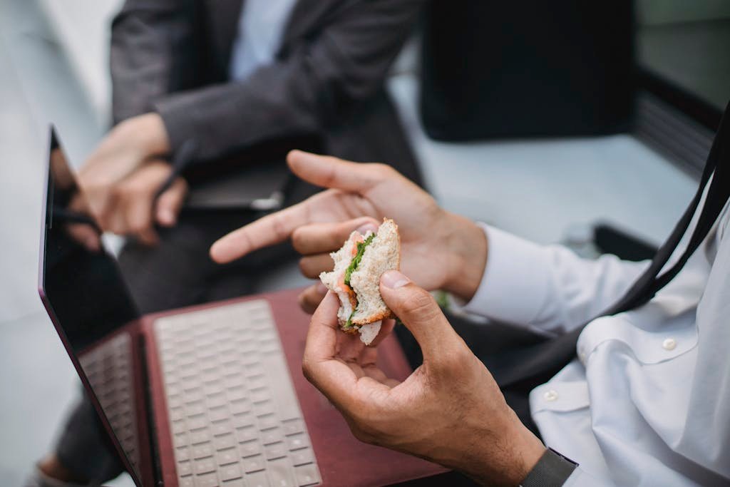 A Close-Up Shot of a Person Holding a Piece of a Sandwich