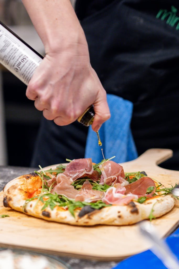 Hand of a Man Preparing Pizza