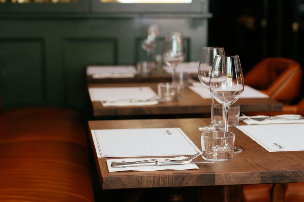 Clear Long-stemmed Wine Glass on Brown Table