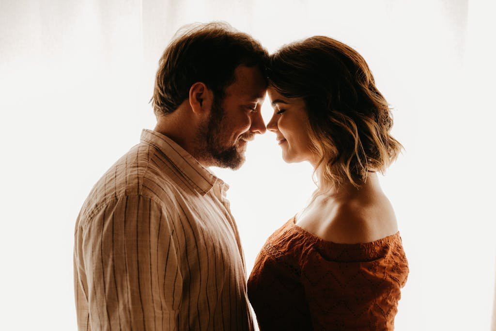 Loving couple standing close in room