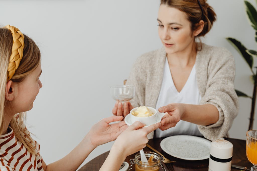 Mother and Daughter Having Breakfast at Home