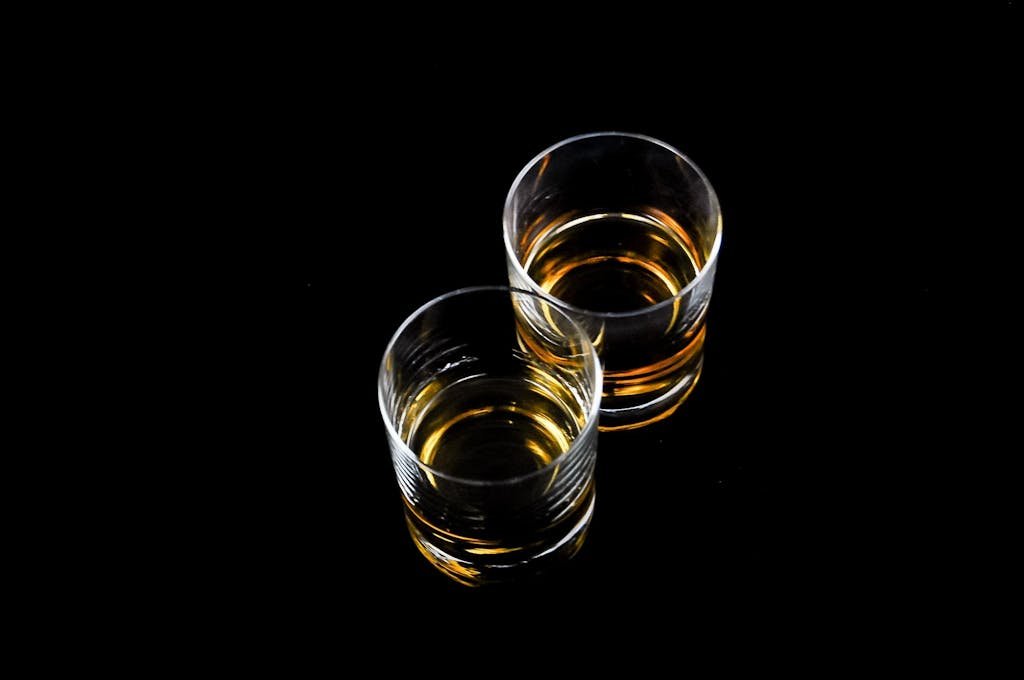 Two Clear Shot Glasses Filled With Liquors